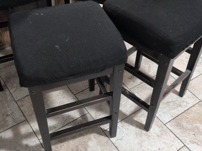 Four Dark Wood Counter Height Bar Stools.