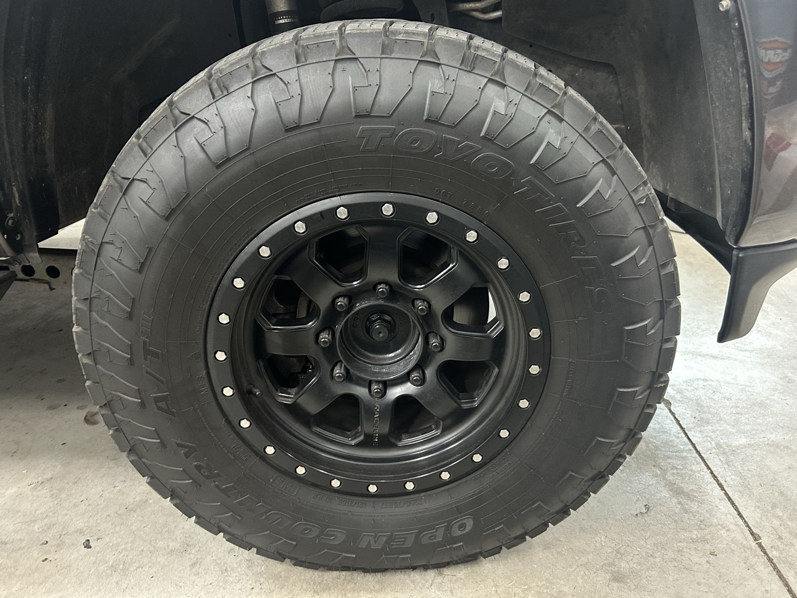 Set of 4 Toyo Open Country A/T III LT285/70R17 Tires with Black Vision 17-inch Wheels