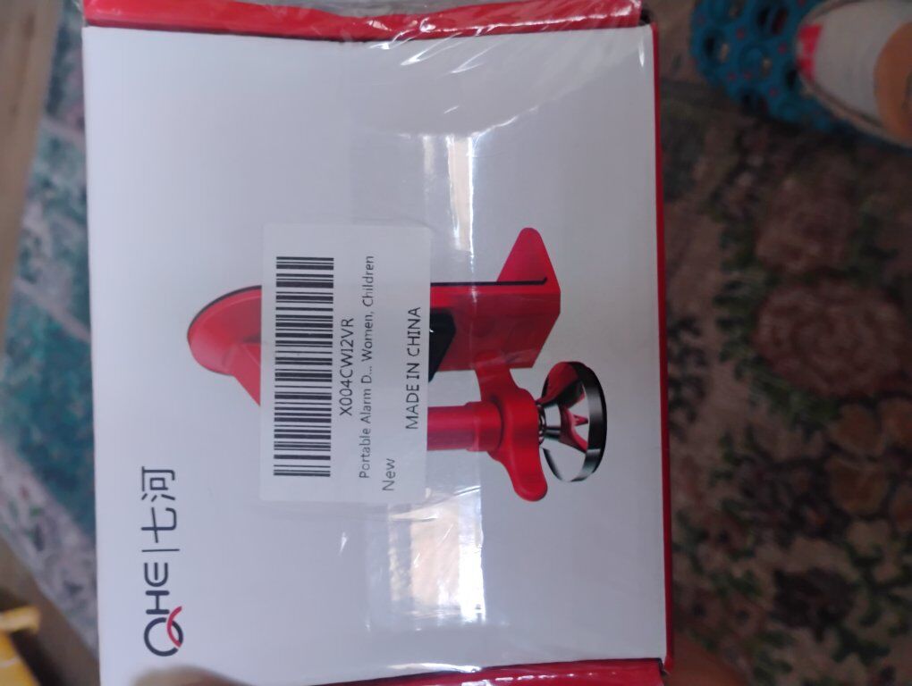 Portable alarm door stopper