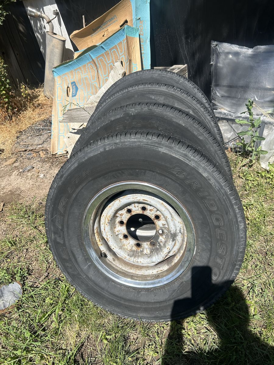 Set of 4 Bridgestone Dueler LTH Tires LT235/85R16 on 8-Lug Steel Wheels