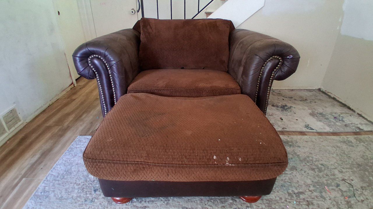 Large brown armchair with matching ottoman w/ nailhead trim