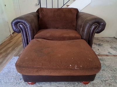 Large brown armchair with matching ottoman w/ nailhead trim