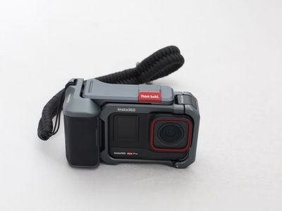Insta360 Ace Pro action camera with Tilta protective cage and wrist strap.