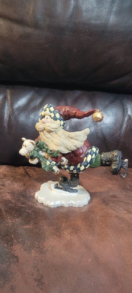 Possible Boyd's bears carvers collection.Quick as a flash. Santa with a bear Ice Skating Christmas Figurine