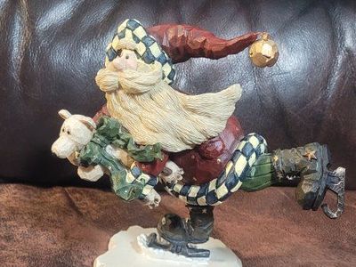 Possible Boyd's bears carvers collection.Quick as a flash. Santa with a bear Ice Skating Christmas Figurine
