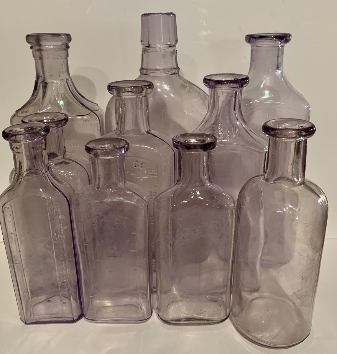 10 old purple whiskey & medicine bottles