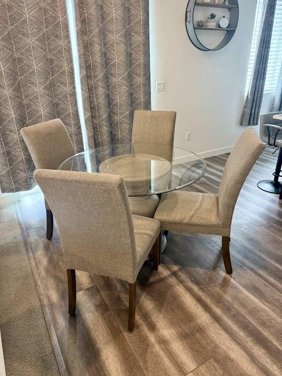 Glass Top Dining Table with Pedestal Base & 4 Upholstered Chairs