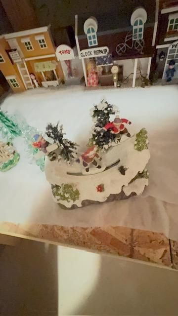 Animated Christmas village ice skating scene, lights, music, moving figures,