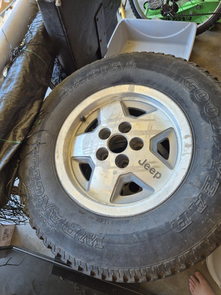 OEM Jeep 5-Spoke Alloy Wheels with Goodyear Wrangler Radial Tires P235/75R15. 3 total