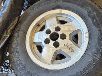 OEM Jeep 5-Spoke Alloy Wheels with Goodyear Wrangler Radial Tires P235/75R15. 3 total