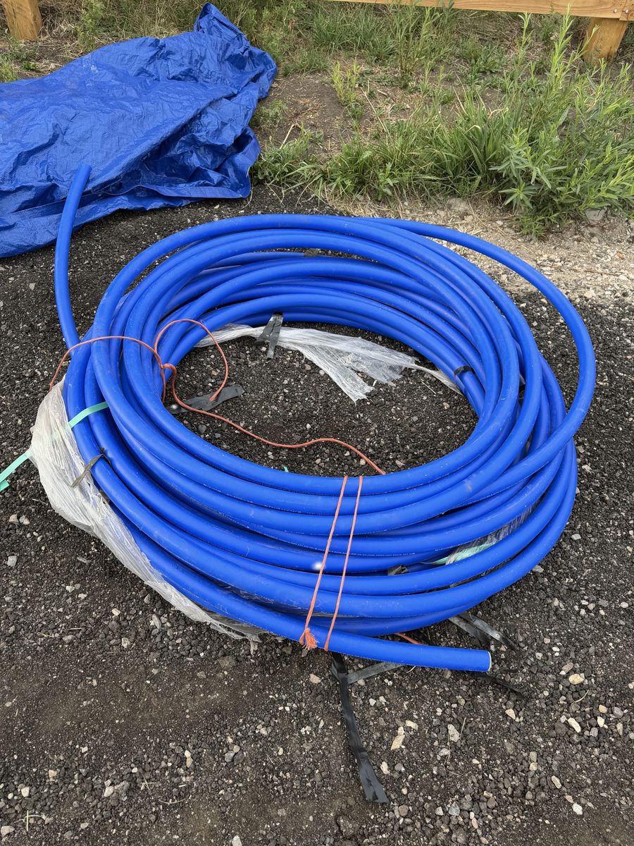 Coil of Blue 1-1/2 Inch HDPE CTS 250 PSI Poly Pipe Water Tubing 230ft