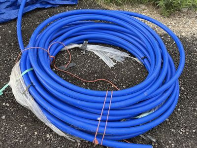 Coil of Blue 1-1/2 Inch HDPE CTS 250 PSI Poly Pipe Water Tubing 230ft