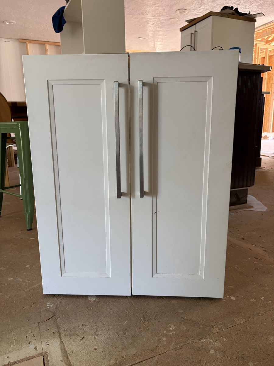 Built in cabinet and boom shelves. All white.
