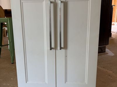 Built in cabinet and boom shelves. All white.