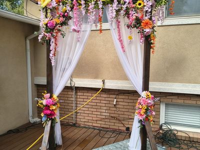 Wedding Arch with Flowers, lights, and drapery
