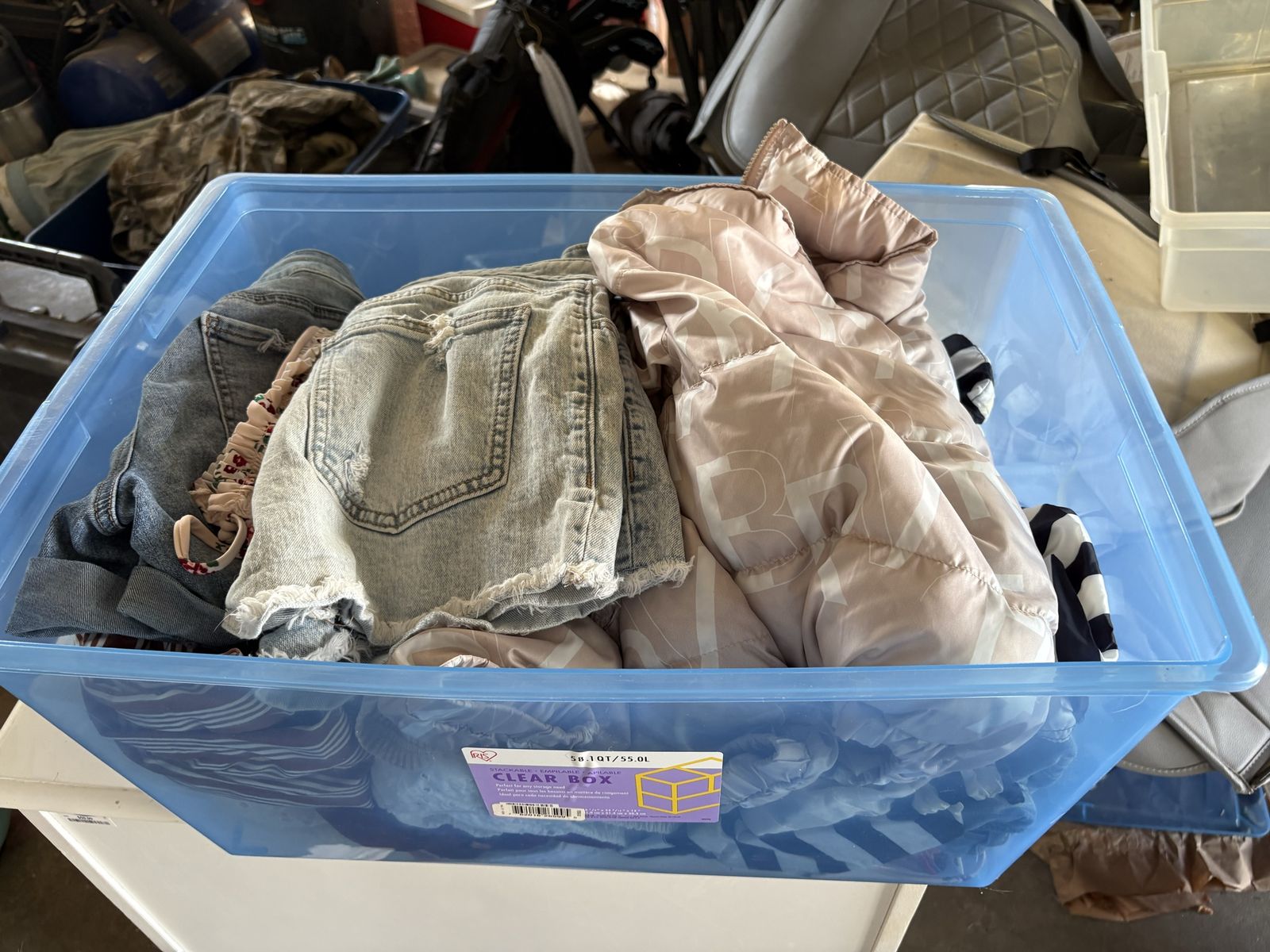 Box of women’s name brand clothing .