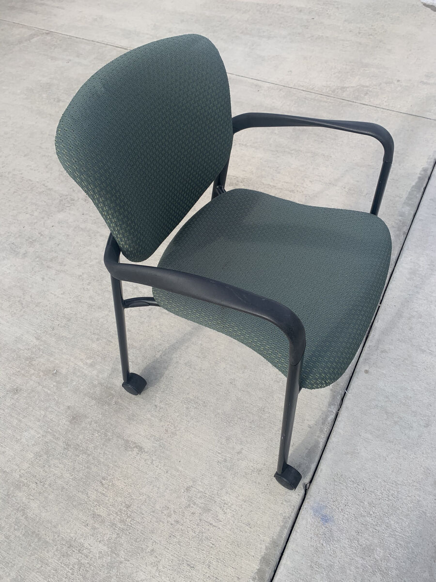 Green padded rolling chair with arms