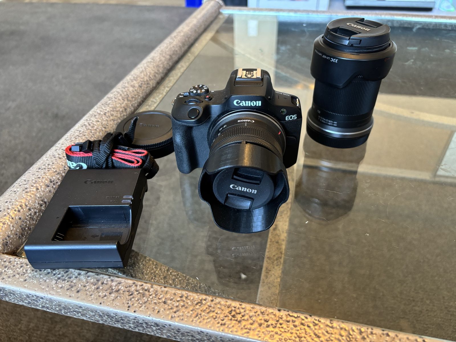 Canon EOS R100 with 18-45mm lens and 18-150mm lens
