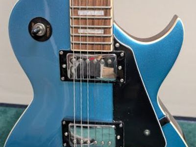 Benssica Les Paul-style electric guitar, metallic blue finish, Dual humbucker pickups, traditional 4-knob control setup