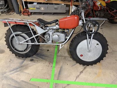 Vintage Two-Wheel Drive Rokon Trail-Breaker Motorcycle with Large Tires and Cargo Racks