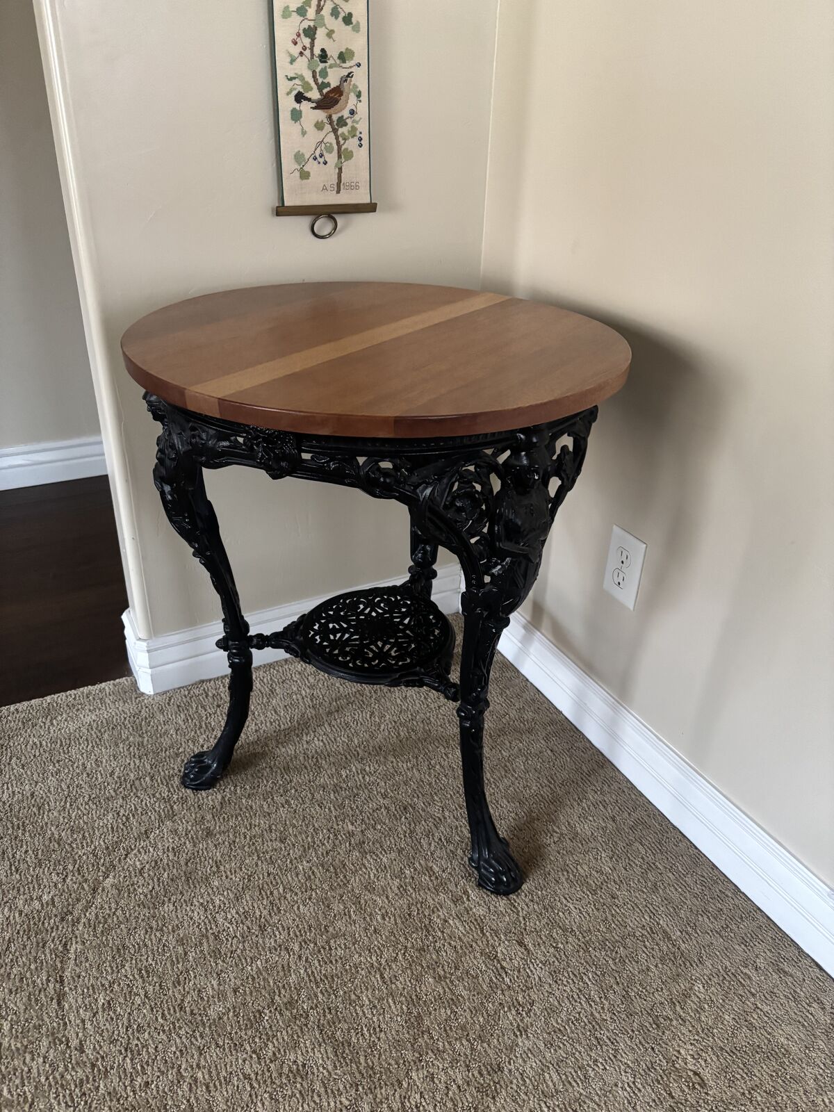 Mahogany table top with decorative iron base and legs.