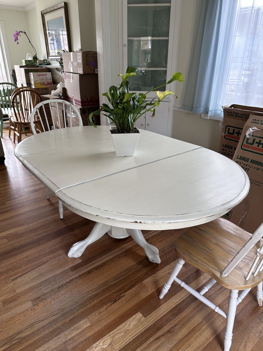 White dining room table with leaf and two chairs