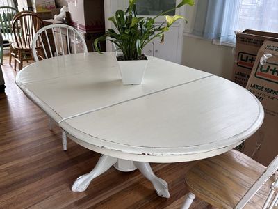 White dining room table with leaf and two chairs