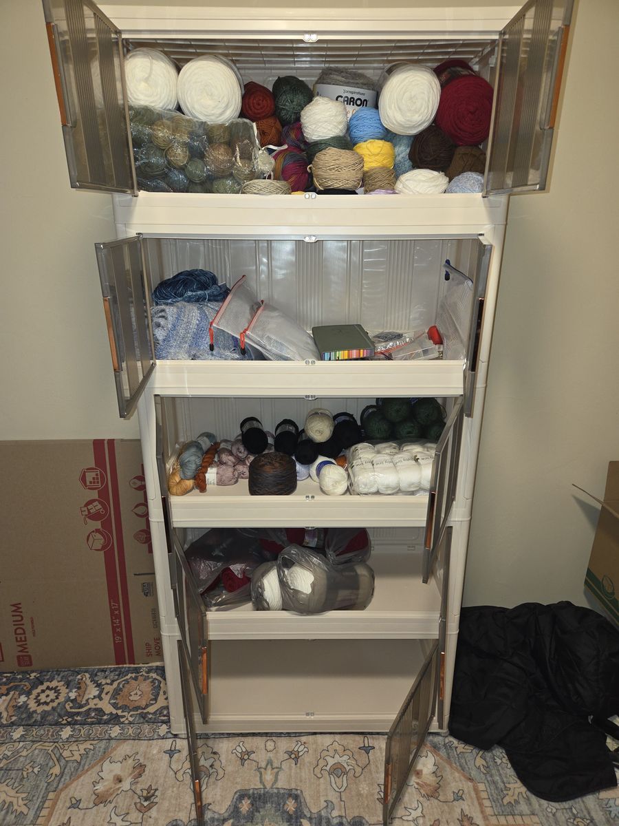 2 cabinets, one filled with yarn and stackable. The other opens up for additional storage on the doors.