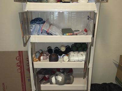 2 cabinets, one filled with yarn and stackable. The other opens up for additional storage on the doors.