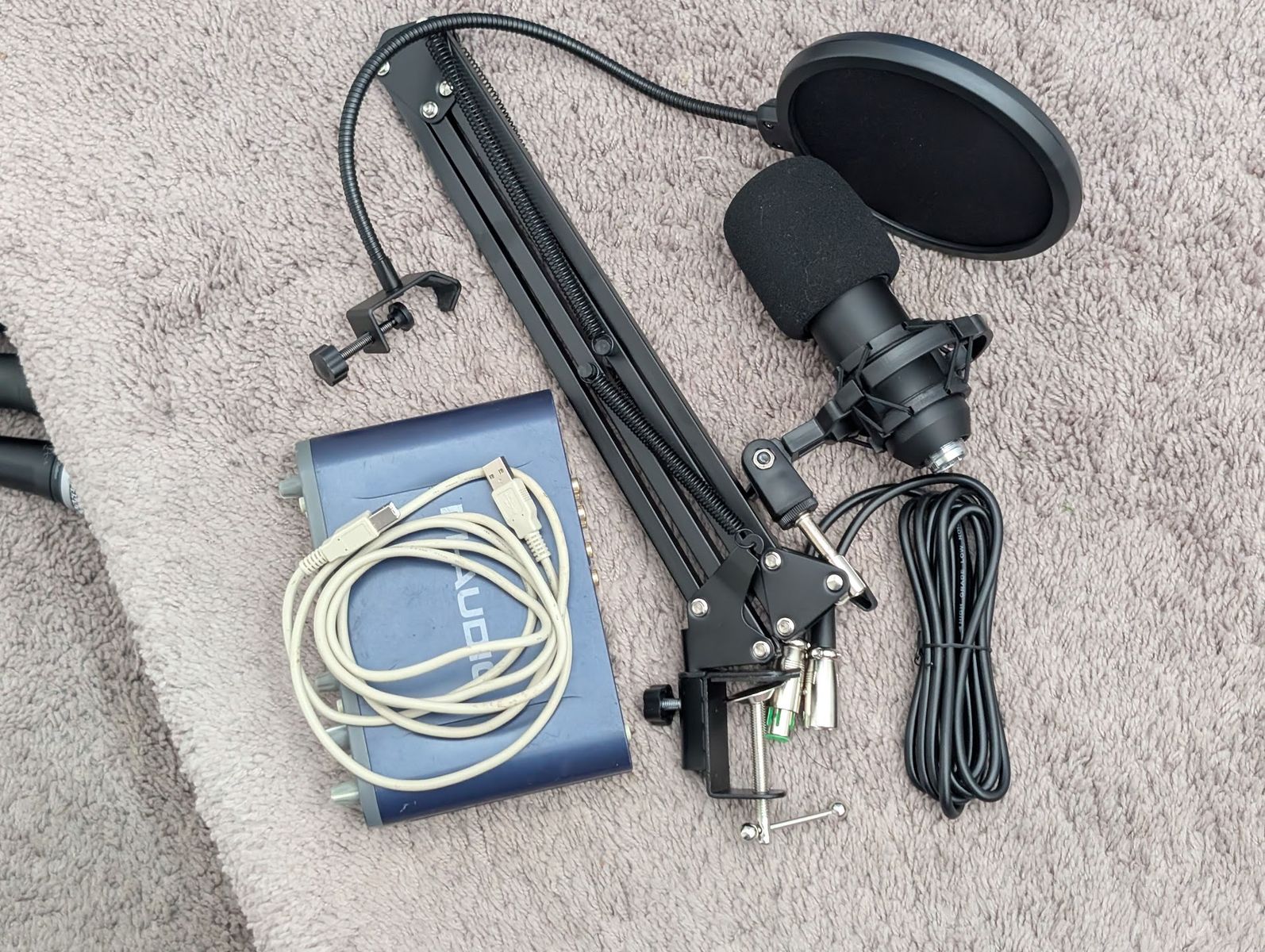 Beginner recording setup with boom arm, m-audio interface
