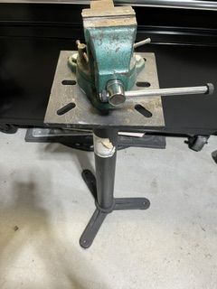 Heavy duty vise mounted on a steel work stand.