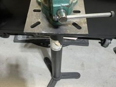 Heavy duty vise mounted on a steel work stand.