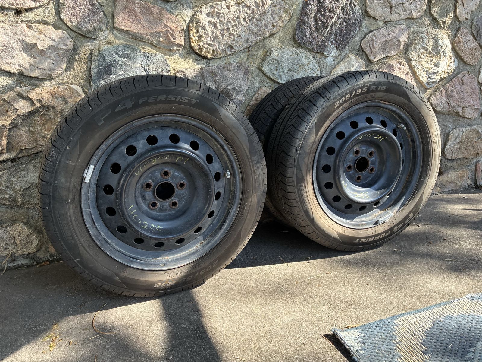 Set of 4 Pirelli P4 PERSIST Tires on Toyota Corolla Steel Wheels