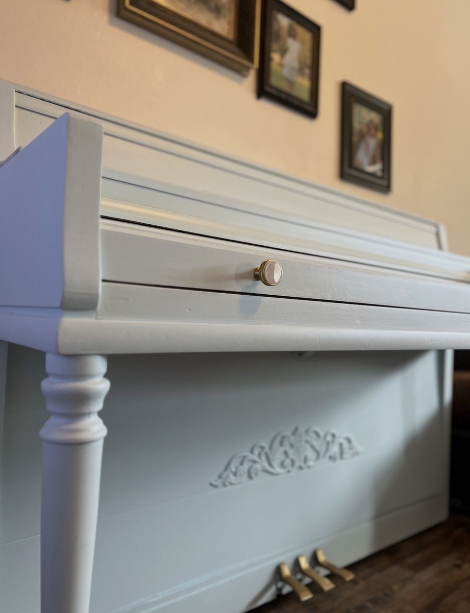 Light blue upright Wurlitzer piano