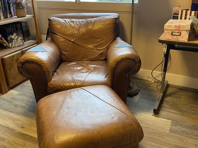 Comfortable leather chair with ottoman