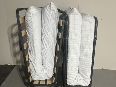 Two foldable guest beds with mattresses and covers