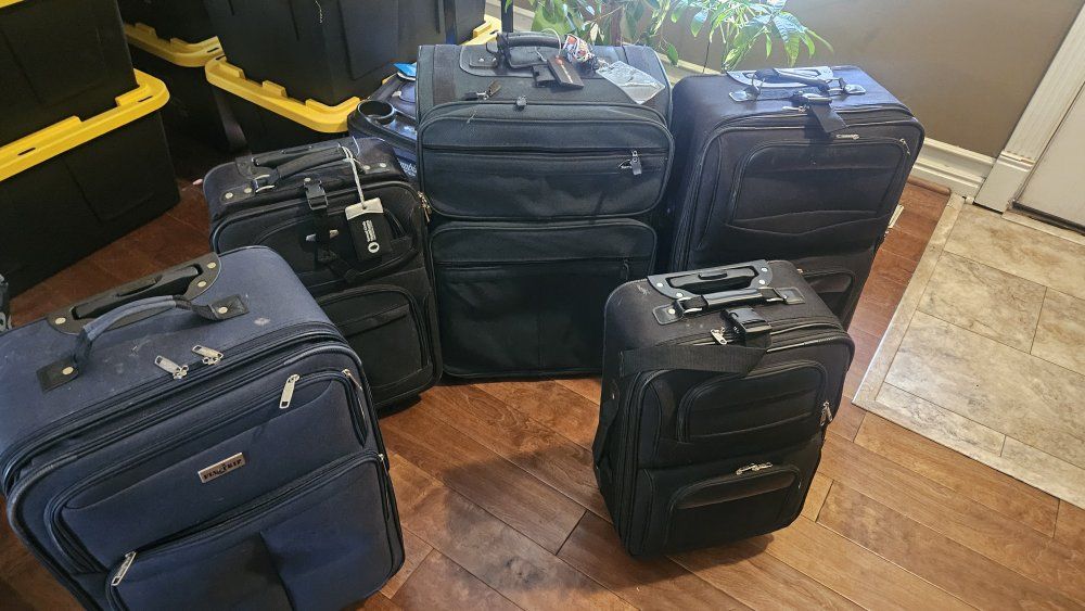 Mixed Lot of 5 Used Travel Luggage Bags - 2 Black Wheeled, 2 Black Carry-on, 1 Blue Wheeled Suitcase