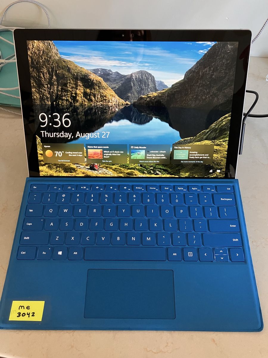 Microsoft Surface Pro Tablet with Blue Keyboard and original charging cable.