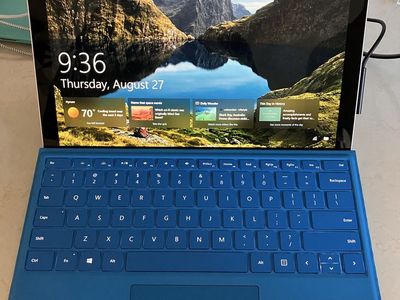 Microsoft Surface Pro Tablet with Blue Keyboard and original charging cable.