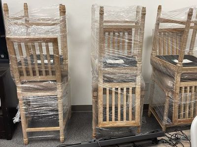 Set of rustic counter-height wooden chairs with a sturdy wood frame and high backrest.