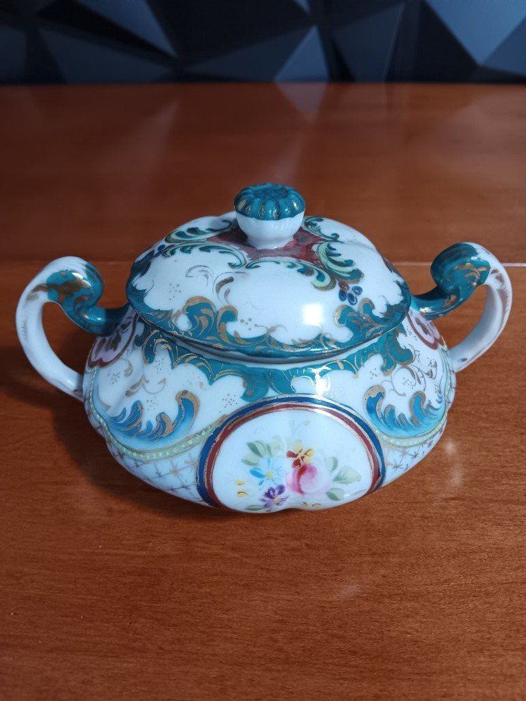 vintage porcelain sugar bowl featuring a Rococo-st