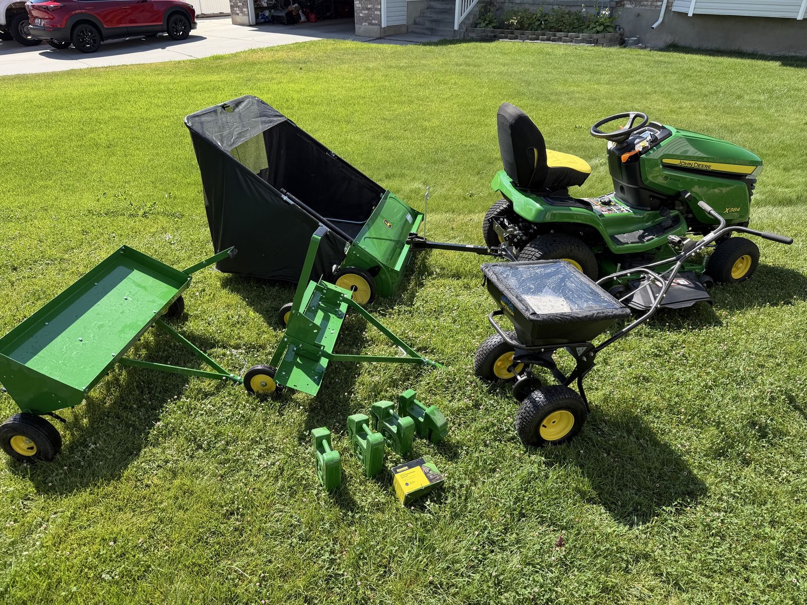 Sale Pending - John Deere X384 Lawn Tractor with Trailer, Sweeper, Dethatcher, Aerator, Spreader, weights, Bat charge