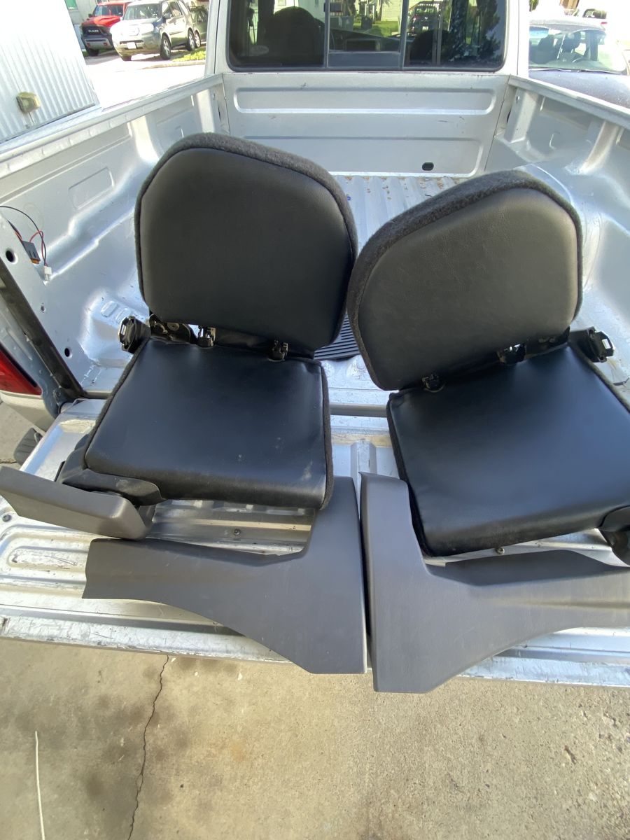 The 2003 Ford Ranger Super Cab XLT FX4 features two inward-facing rear "jump" seats.