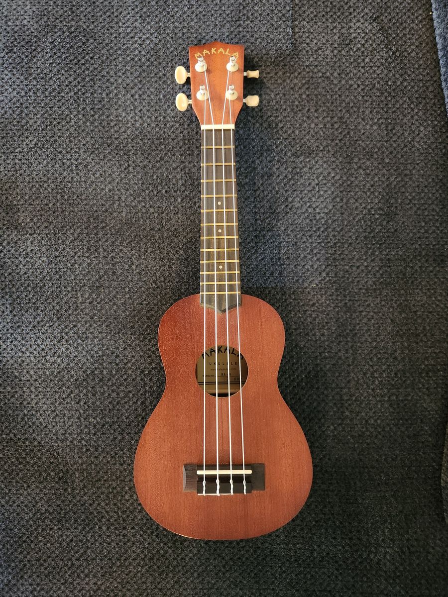 Ukulele with case and clip-on digital tuner