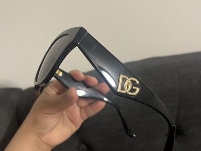 Burberry black sunglasses with a tan case. They are in excellent condition.