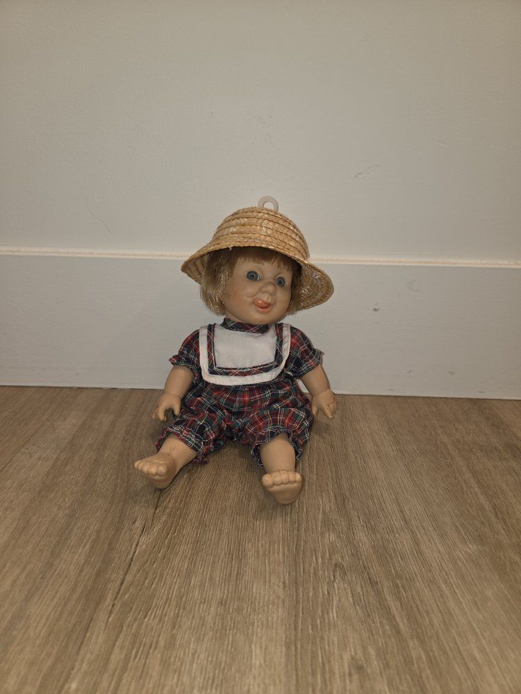 Vintage Porcelain Collectible Doll with Straw Hat and Plaid Romper