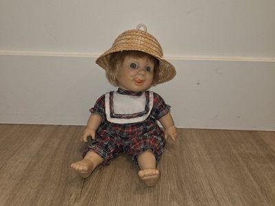 Vintage Porcelain Collectible Doll with Straw Hat and Plaid Romper