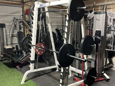 $3800 LIFE FITNESS SMITH MACHINE & ROGUE WEIGHTS