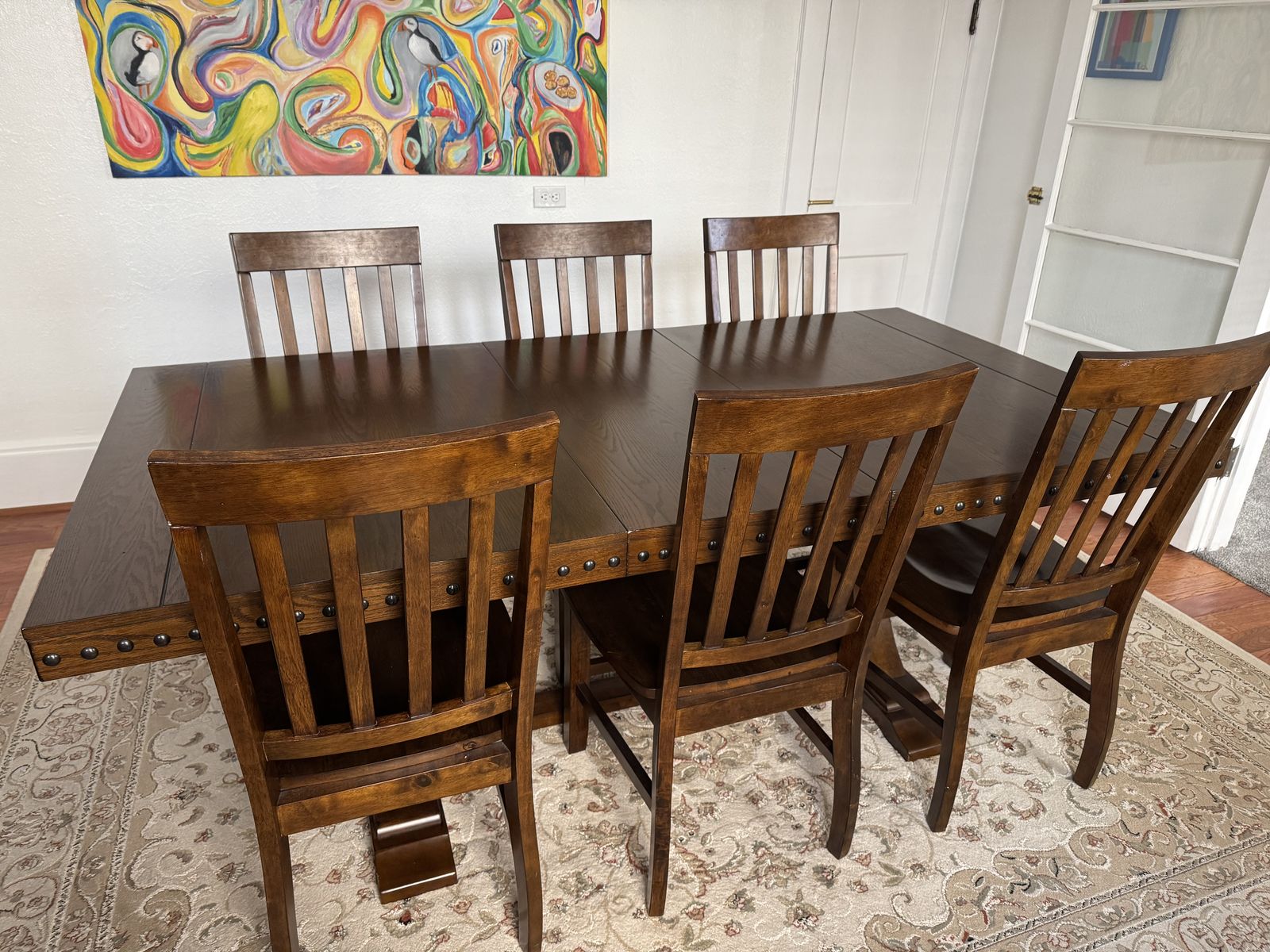 Spacious Dark Wood Dining Table with 6 Matching Chairs - Trestle Base, Studded Trim