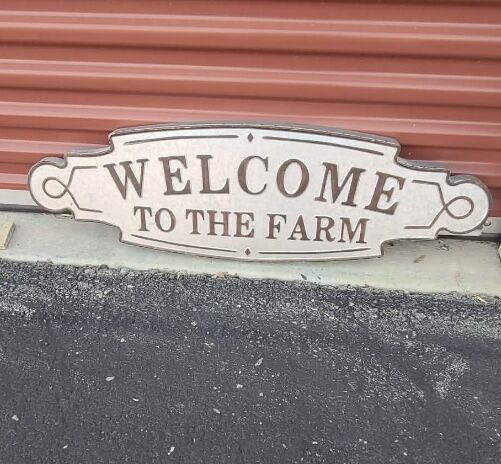 Galvanized metal “Welcome to the Farm” sign .